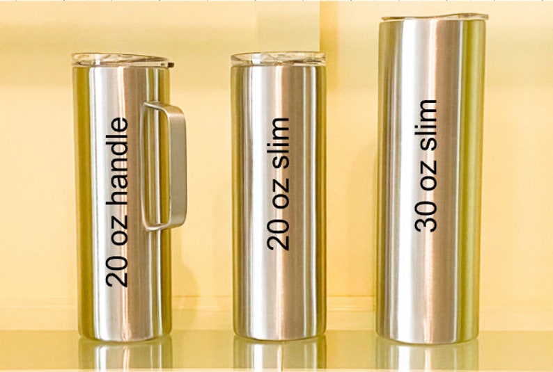 May include: Three stainless steel tumblers with lids. The tumblers are labeled 20 oz handle, 20 oz slim, and 30 oz slim.