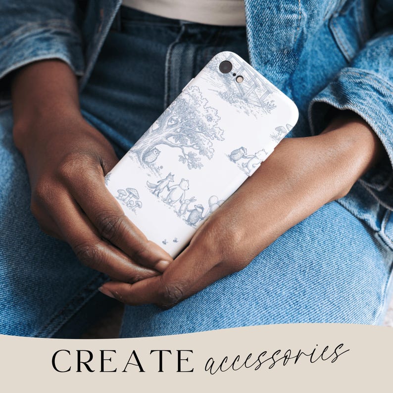 May include: A white phone case with a blue and gray illustration of woodland creatures and trees. The phone case is held in a person's hands, with the text "CREATE accessories" at the bottom.