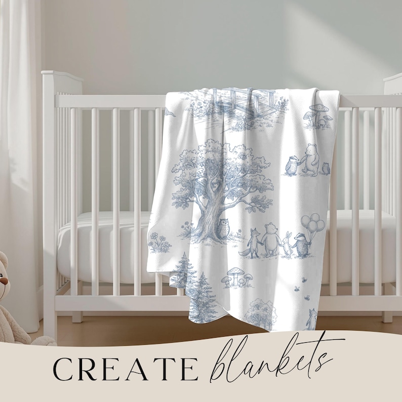 May include: White baby blanket with a blue illustrated forest scene featuring animals and trees. The blanket is draped over a white crib. The words "CREATE blankets" are written in black script at the bottom of the image.