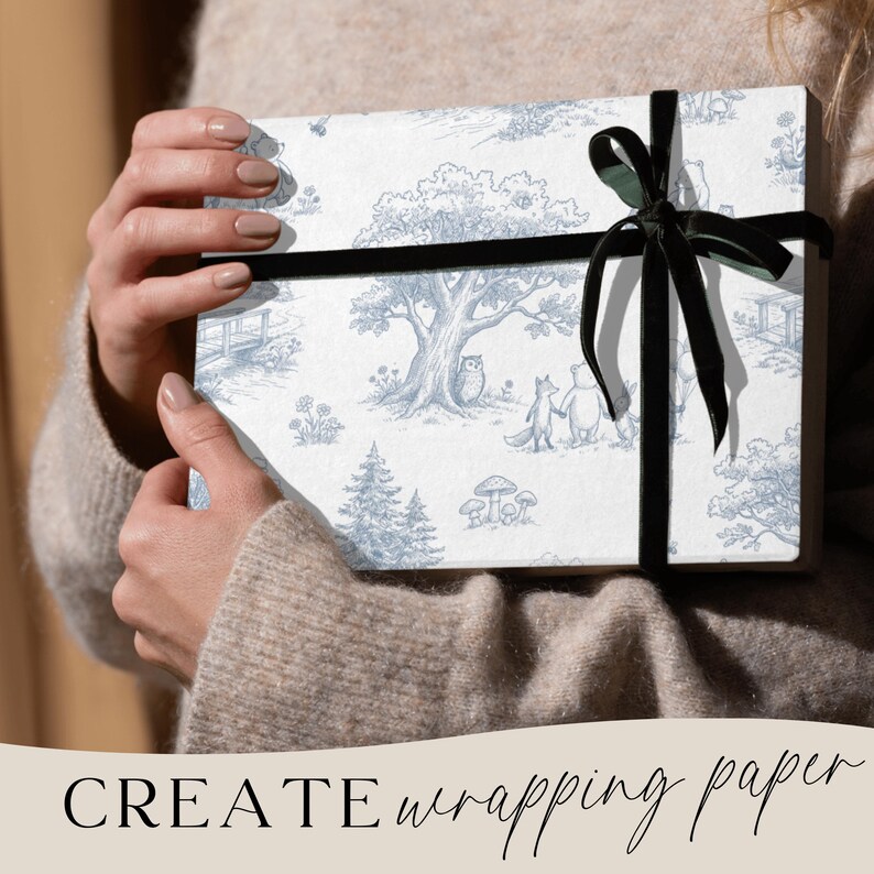 May include: A wrapped gift box featuring a blue and white toile design with forest animals and trees. The box is tied with a black velvet ribbon. The words "CREATE wrapping paper" are at the bottom of the image.