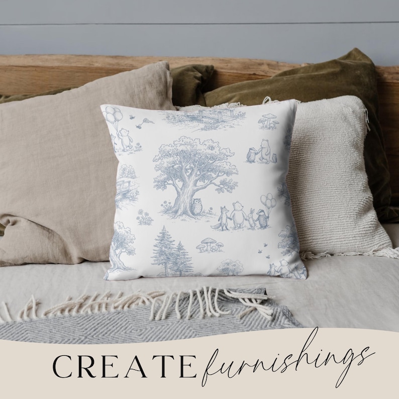 May include: A square throw pillow with a blue and white toile pattern featuring a tree, characters, and other elements. The pillow is surrounded by other pillows in neutral colors. The words "CREATE furnishings" are at the bottom.