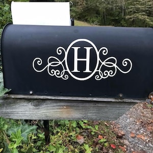 May include: Black mailbox with a white monogram decal featuring the letter "H" in a circle with decorative swirls.