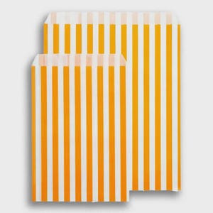 May include: Two rectangular paper bags featuring a vertical striped pattern in bright yellow and white. The bags are positioned one slightly behind the other, displaying a consistent alternating colour design across the entire surface of the paper.