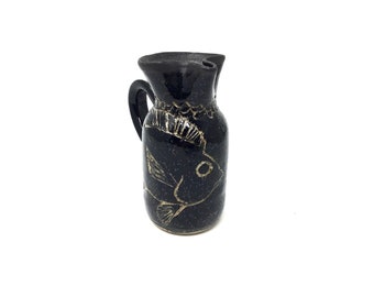 Small ceramic pitcher with image of fish. Scraffito, black and beige, hand painted, 10 oz