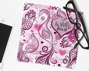 May include: A pink and purple microfiber cleaning cloth with a paisley pattern and the text "be still & know".