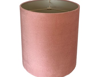 May include: A dusty rose pink velvet lampshade with a gold metal frame.