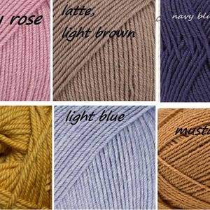May include: A collection of yarn skeins in various colors, including dusty rose, latte, light brown, navy blue, yellow, light blue, and mustard.