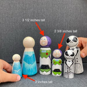 May include: Five wooden peg dolls, hand-painted with different characters. The dolls are 5.1 cm, 6.0 cm, and 8.9 cm tall.