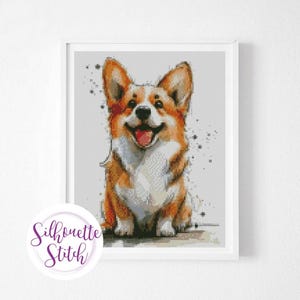 May include: A cross stitch pattern featuring a smiling corgi dog with brown and white fur. The dog is sitting with its paws crossed and has a happy expression on its face. The background is a light gray with a few black dots.