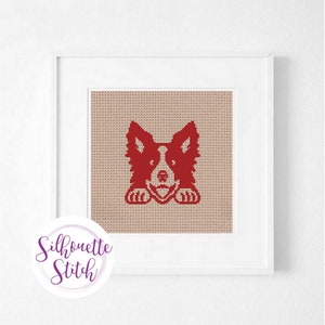 May include: Red silhouette of a dog peeking out from behind a beige background. The dog is looking directly at the viewer with its tongue sticking out. The image is framed in a white frame.