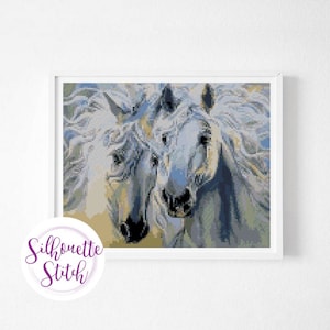 May include: A close-up of two white horses with flowing manes. The horses are facing the viewer and their heads are touching. The background is a blur of blue and green.