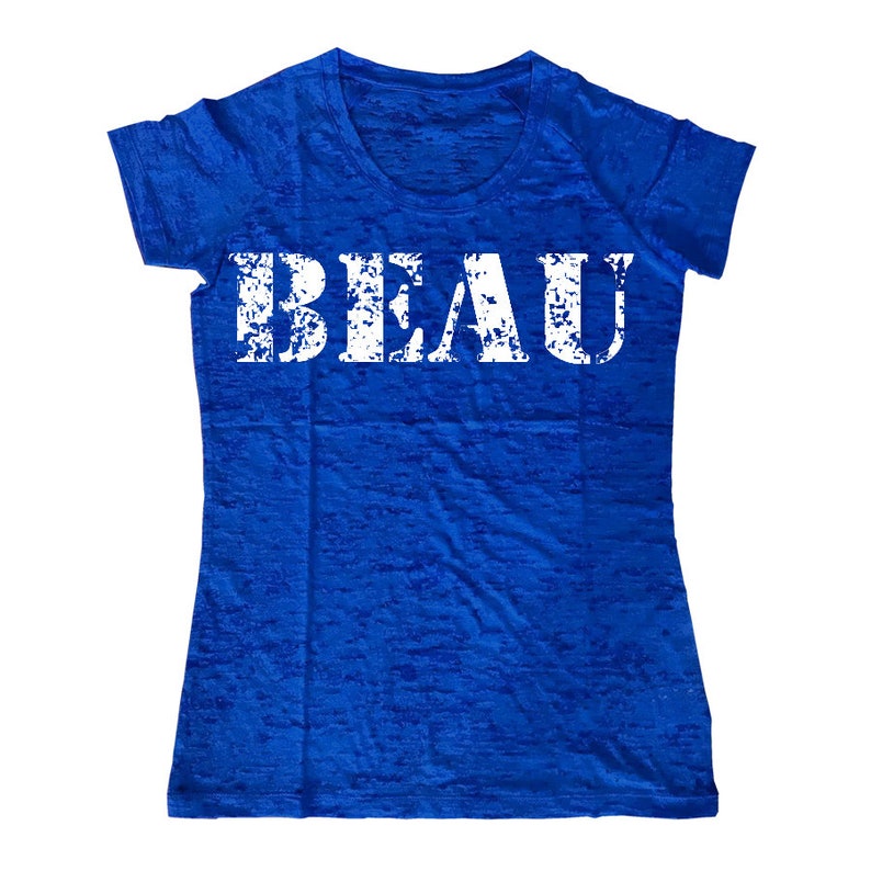 May include: A royal blue t-shirt with a white distressed graphic that says "BEAU".