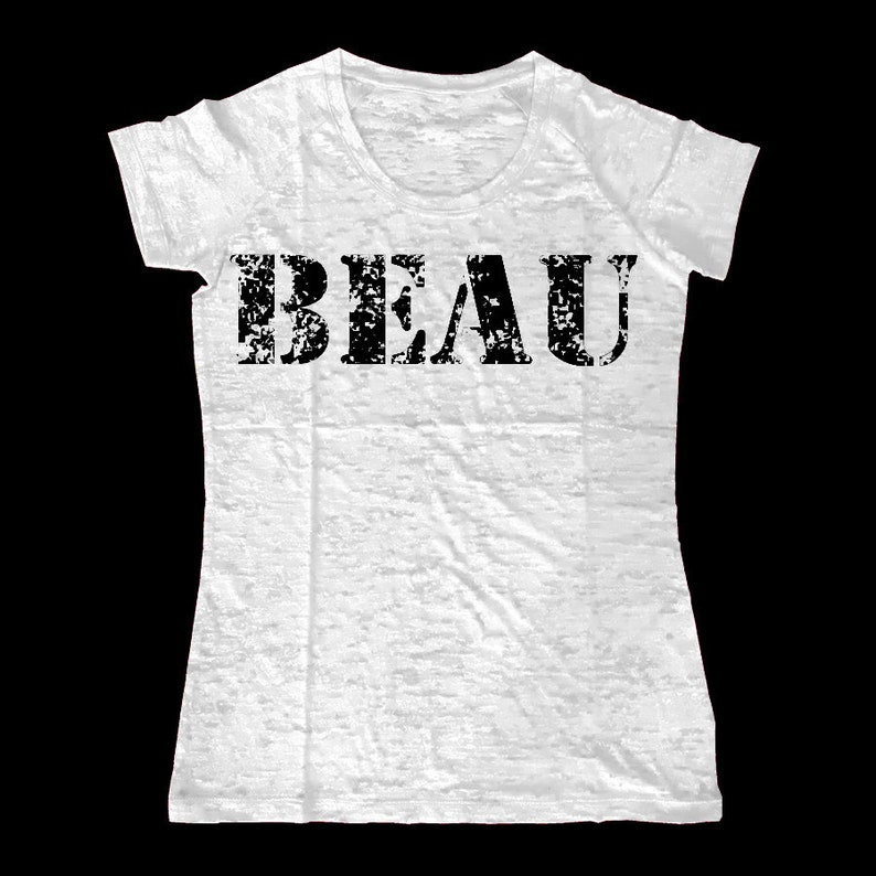 May include: White t-shirt with a distressed black print of the word "BEAU".