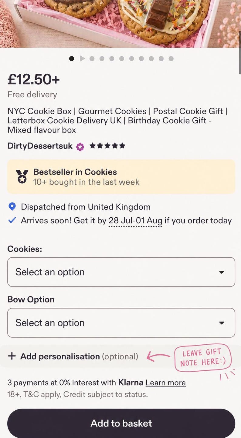 May include: A gift box containing round cookies topped with white icing, colourful sprinkles, and chocolate bar pieces. The cookies are nestled on pink shredded paper inside a rectangular box, presented with an online ordering interface.