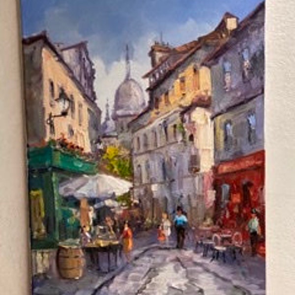 Parisian life in Montmartre- Impressionism - Vivid life with artist, artisans, people in cafes at the Sacré Couer Basilica way at back view.