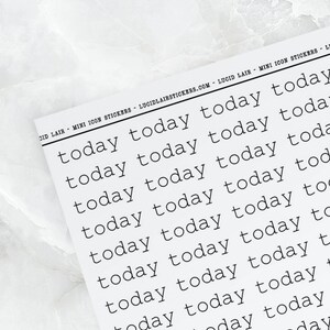 May include: A rectangular sticker sheet featuring a repeating pattern of the word today printed in a black typewriter-style font. The top margin includes the text LUCID LAIR MINI ICON STICKERS LUCIDLAIRSTICKERS.COM LUCID LAIR MINI ICON STICKERS.