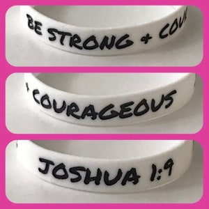 May include: Three white silicone wristbands with black lettering. The first wristband says "Be Strong + Courageous". The second wristband says "Courageous". The third wristband says "Joshua 1:9".