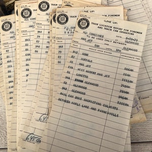May include: A stack of vintage train conductor's time sheets with a train location report for foremen and trace car operators. The report is dated September 19, 1973 and lists the approximate time for various train stops between 8:00 AM and 1:00 PM. The report includes stops at Gone, Buffalo, MNS JCT, West Mayfrt HNS JCT, Loretto, XEXM GLENWOOD, GLENWOOD, and more.