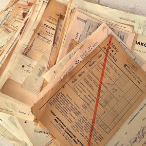 May include: A collection of vintage documents, including invoices and forms, with handwritten notes and stamps. The papers are aged with a yellowed, textured appearance, and feature text in multiple languages. The documents are stacked together, creating a layered effect.