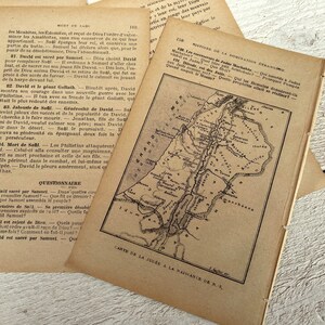 May include: A vintage, black and white map of the land of Judea, showing the location of Jerusalem and other cities. The map is printed on a page from an old book, with text in French.