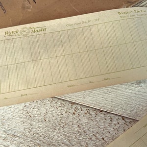 May include: A vintage Western Electric Watch Rate Recorder chart paper, labeled "Chart Paper No. 5C - 105" and "Watch Rate Recorder". The paper is beige with green lines and has spaces for "Watch", "No.", and "Date".