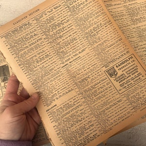 Könnte beinhalten: Eine Nahaufnahme eines alten Kleinanzeigen-Abschnitts aus einer Zeitung. Die Seite ist mit kleinen Anzeigen für verschiedene Unternehmen und Dienstleistungen gefüllt. Der Text enthält Überschriften wie "Kleinanzeigen", "Emulsionen" und "Emaille-Hersteller". Eine kleine Anzeige für Randolph Products Co. ist in der unteren rechten Ecke sichtbar und wirbt für Lacke, synthetische Emaille, Verdünner und Flugzeug-Dope.