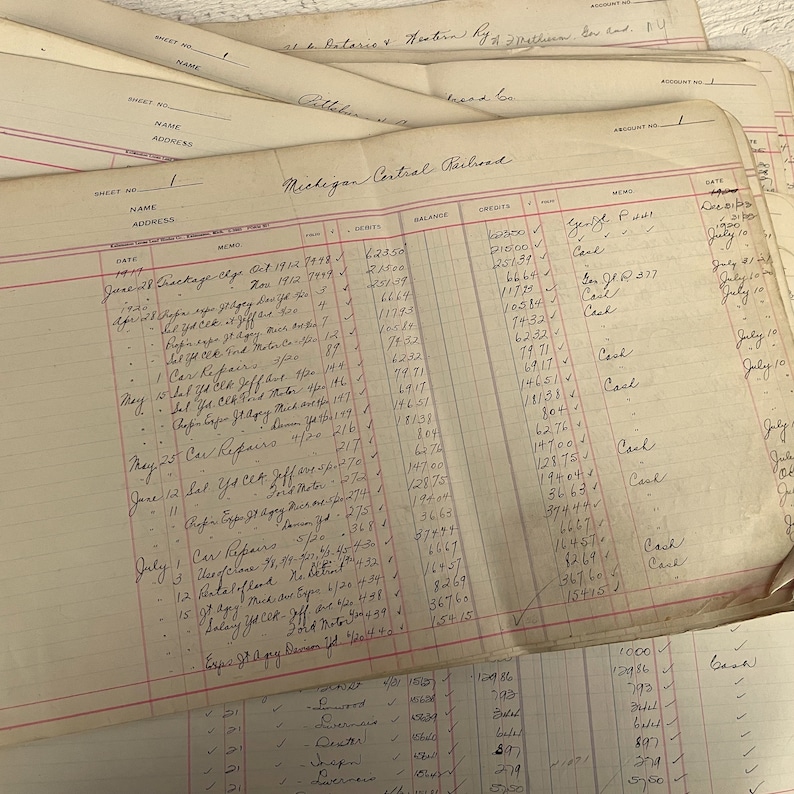 May include: A close-up of a ledger page with handwritten entries for the Michigan Central Railroad. The page shows dates, debits, credits, and a balance column. The entries include details like "Car Repairs", "Crockage", and "Salvage".