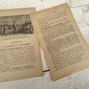 May include: A black and white illustration of a historical scene depicting a man riding a donkey with a crowd of people following behind. The image is from a book titled "La Passion de N. S. Jesus Christ" and includes the text "CHAPITRE IX".