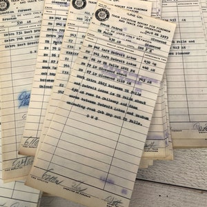 May include: A stack of vintage train location report forms for foremen and trace car operators. The forms are printed on white paper with blue ink and have a date of June 26, 1973. The forms list train numbers, locations, and approximate times.