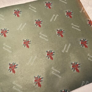 May include: Green wrapping paper with a repeating pattern of red and green wreaths and the text "Seasons Greetings".