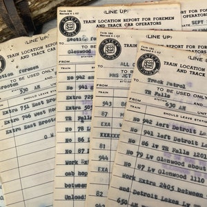 May include: A collection of vintage train location report forms with the text "Safety First" printed on each form. The forms are filled out with handwritten information about train locations and times. The forms are dated September 28, 1973.
