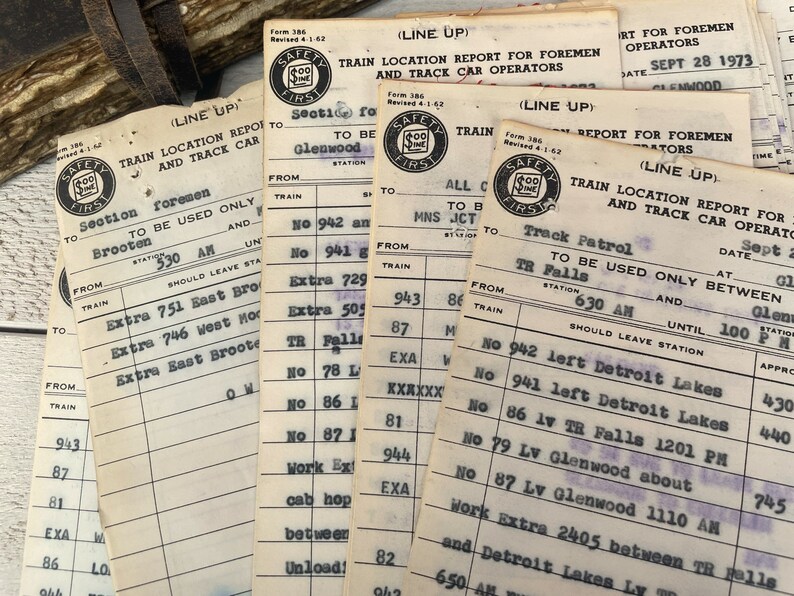 May include: A collection of vintage train location report forms with the text "Safety First" printed on each form. The forms are filled out with handwritten information about train locations and times. The forms are dated September 28, 1973.