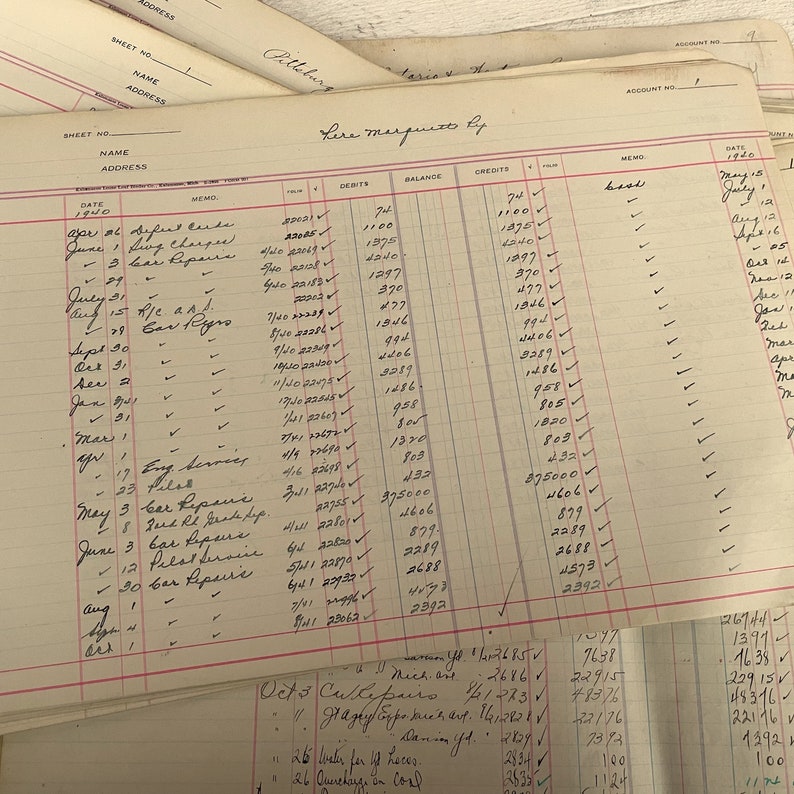 May include: A vintage ledger book with handwritten entries in black ink. The book is open to a page titled "Lera Magnuto By" and shows a detailed record of debits, credits, and balances for the year 1950.
