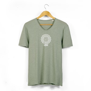 May include: A green short-sleeved t-shirt with a white mandala design and the word "सत्यमेव जयते" printed on the front.
