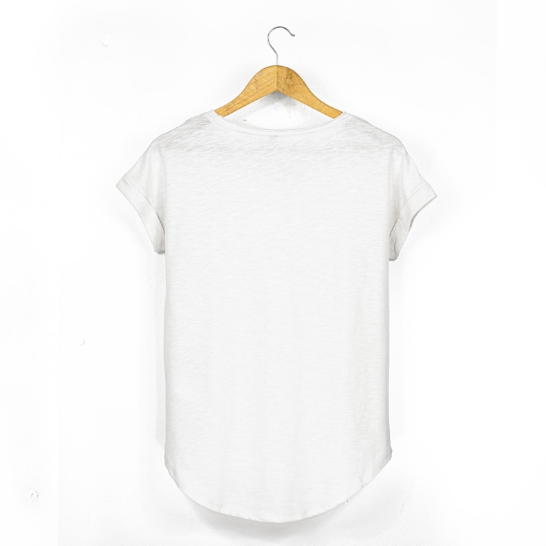 Back view of women’s white slub cotton t shirt with rolled sleeves and curved drop hem, relaxed fit and plain finish.