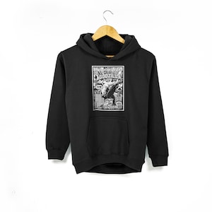 May include: Black hooded sweatshirt with a white graphic print of a Godzilla poster. The poster features the text "GODZILLA" and Japanese characters.