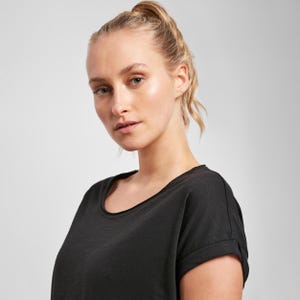 Woman wearing black scoop neck t shirt front view, relaxed fit with soft fabric and clean minimalist style suitable for everyday wear