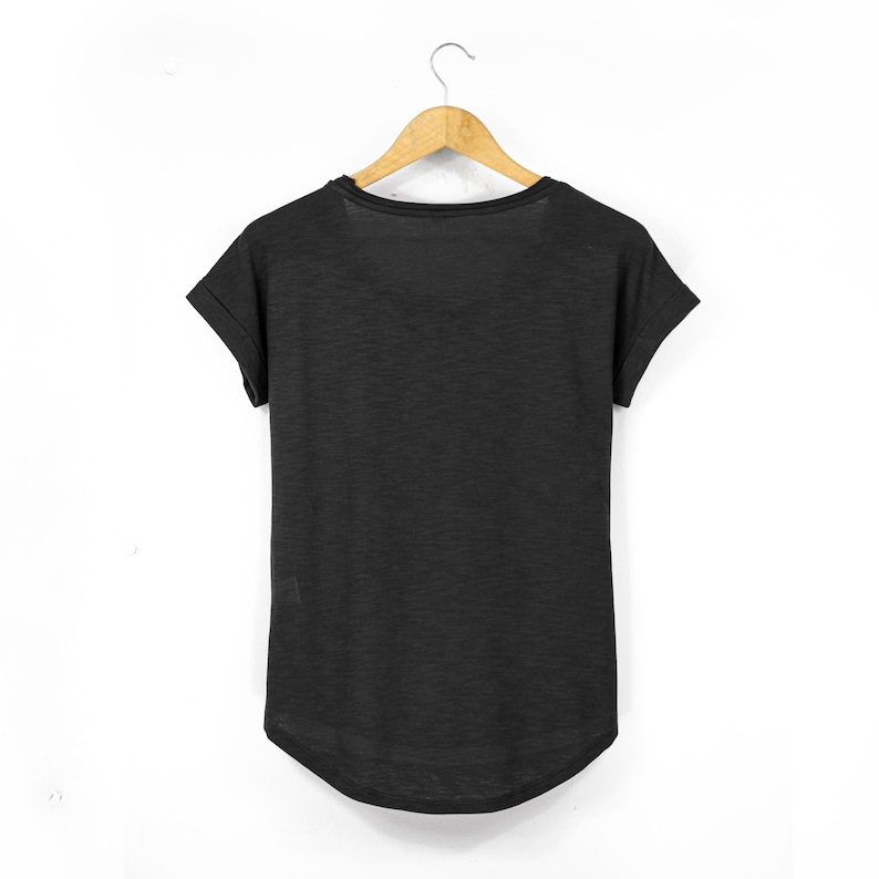 Black womens t shirt back view showing clean plain design, relaxed fit with curved hem and slightly longer back length, lightweight cotton fabric with soft texture and casual silhouette