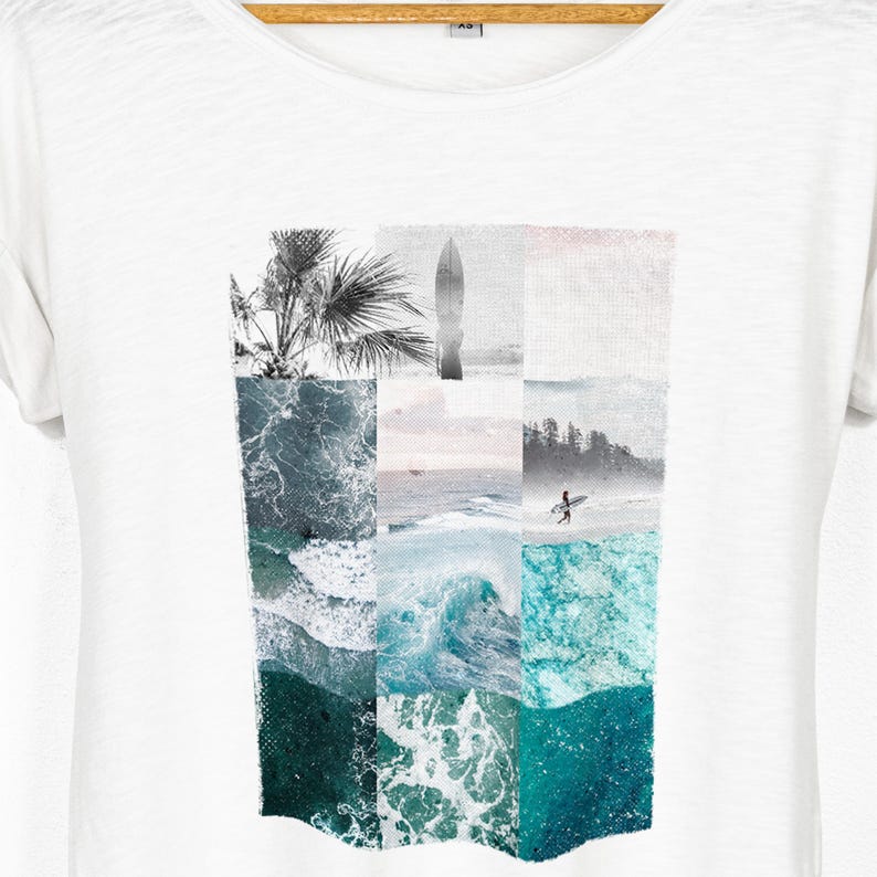 White relaxed fit women's t-shirt with rolled sleeves featuring a coastal collage graphic made from ocean waves, tropical palms, a surfboard silhouette, seaside horizon and surfer photography in muted turquoise, seafoam and soft grey tones.