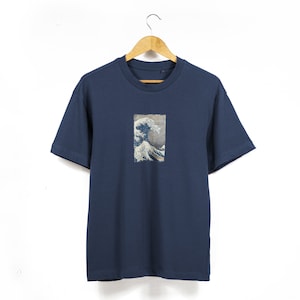 May include: A navy blue t-shirt with a graphic print of a famous Japanese wave painting.