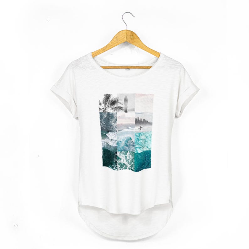 White relaxed fit women's t-shirt with rolled sleeves featuring a coastal collage graphic made from ocean waves, tropical palms, a surfboard silhouette, seaside horizon and surfer photography in muted turquoise, seafoam and soft grey tones.