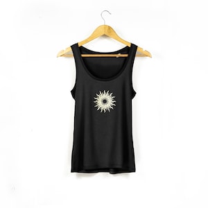May include: Black tank top with a white sun graphic.