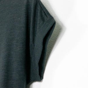 Close-up of rolled sleeve on black t shirt, relaxed fit with soft fabric and casual finish, lightweight cotton with subtle texture