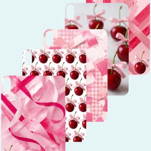 May include: A collection of phone cases with various pink designs. Some cases feature a pattern of cherries with pink bows, while others have abstract brushstrokes or ribbon-like patterns. The cases are arranged in a layered, cascading style.