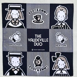 May include: Square, navy blue and white handkerchief featuring cartoon illustrations of characters and the text "EDDY & EMMY" and "THE VAUDEVILLE DUO". The handkerchief also includes the text "BROADWAY" and "NEW YORK".