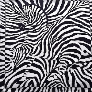 May include: A black and white patterned square scarf featuring a zebra print design.