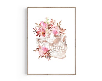 May include: A watercolor illustration of a human skull with pink and red flowers. The skull is in a rose gold color and the flowers are arranged around the skull's head.