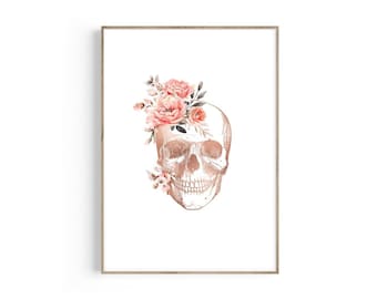 May include: A white anatomical skull with a floral crown of pink roses and leaves. The skull is in a gold tone and the flowers are painted in a watercolor style.