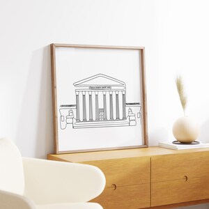 May include: A black and white line drawing of the Supreme Court building in Washington, D.C. The drawing is framed in a light wood frame and is hanging on a white wall.