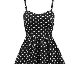 May include: A black and white polka dot sleeveless dress with a sweetheart neckline and a flared skirt.